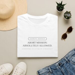 Abort Mission tee by Low Battery Club — cream shirt with ink safety-notice print — product photo 1